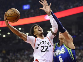 Toronto Raptors guard Patrick McCaw (22) goes up for a shot as Dallas Mavericks forward Kristaps Porzingis (6) defends in Toronto, Sunday, Dec. 22, 2019. (THE CANADIAN PRESS/Frank Gunn)