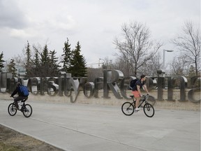 A couple of cyclists ride past University of Regina the newly unveiled Gateway project in Regina, SK, on Friday, May 16, 2014.