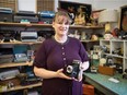 Ada Bennett, managing director of YQR Vintage Market, holds a vintage camera while standing in her section of the market located on Osler Street in Regina, Saskatchewan on Jan. 3, 2020.
