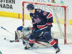 The Regina Pats' Drew Englot attempts to tip a puck past Swift Current Broncos goalie Reece Klassen during a Jan. 4 WHL game at the Brandt Centre.