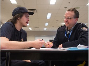 Isaih Daniels, left, works with RCMP Cst. Tony Curti during a youth workshop being held at the RCMP Academy, Depot Division on Dewdney Avenue in Regina, Saskatchewan on Jan 8, 2020.