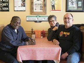 Shirley Wagman, back right, and Eric Johnson, owners of Smokin' Okies, set up a GoFundMe page that has raised $65,000 to assist Saskatchewan Roughriders legend George Reed, left, who is dealing with mobility issues.