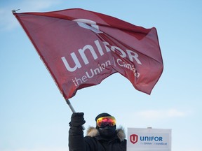 REGINA, SASK : January 21, 2020  -- A person waves a flag during a Unifor rally being held outside the Co-op Refinery Complex on Fleet Street in Regina, Saskatchewan on Jan 21, 2020. BRANDON HARDER/ Regina Leader-Post