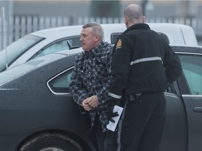Jason McKay, left, arrives in custody at Regina Court of Queen's Bench in January 2020. He was later convicted of second-degree murder in the death of his wife Jenny McKay.