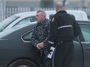 Jason McKay, left, convicted of second-degree murder of his wife Jenny McKay, arrives in custody at Regina's Court of Queen's Bench in Regina, Saskatchewan on Jan. 24, 2020.