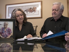 Joanne Monz and her brother Gerry Thomas look through some medical records of their late mom Jean Thomas in Regina. In a confused and agitated state, Jean called 9-1-1 from the hospital after she was confronted by security officers.