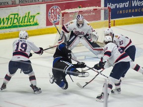 The Victoria Royals' Brayden Tracey is sent flying as he approaches the Regina Pats' net Friday night at the Brandt Centre.