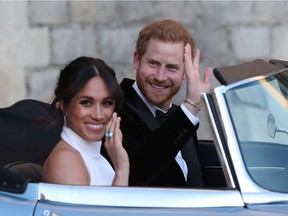 Duchess of Sussex and Prince Harry, Duke of Sussex wave as they leave Windsor Castle after their wedding to attend an evening reception at Frogmore House, hosted by the Prince of Wales on May 19, 2018 in Windsor, England.