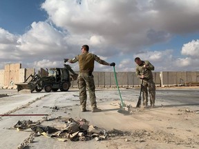 A file picture taken on January 13, 2020 during a press tour organized by the US-led coalition fighting the remnants of the Islamic State group, shows US soldiers clearing rubble at Ain al-Asad military airbase in the western Iraqi province of Anbar.