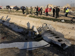 Debris is seen from an Ukrainian plane which crashed as authorities work at the scene in Shahedshahr, southwest of the capital Tehran, Iran, Wednesday, Jan. 8, 2020. A Ukrainian airplane carrying 176 people crashed on Wednesday shortly after takeoff from Tehran's main airport, killing all onboard.