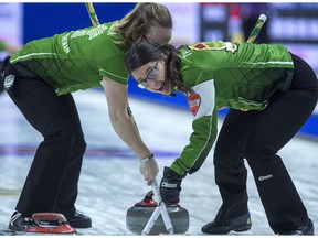 Jessie Hunkin, left, and lead Kara Thevenot sweep a rock during last year's national Scotties.