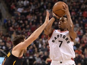 Raptors guard Kyle Lowry (right) shoots for a basket against the Cavaliers in first half NBA action at Scotiabank Arena in Toronto, Tuesday, Dec. 31, 2019.
