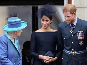 Queen Elizabeth II, Meghan, Duchess of Sussex, Prince Harry, Duke of Sussex at Buckingham Palace for an event to mark the centenary of the RAF, July 10, 2018.