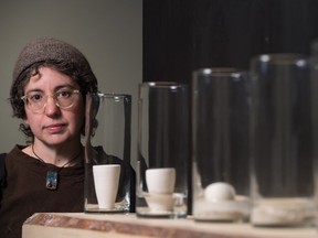 Artist Amy Snider stands behind an active art installation called Calving, which is part of House on Fire. The installation shows the active disintegration of a number of clay cups in jars containing water. Also included is a video, which gives viewers a chance to speed up their view of how the clay disintegrates.