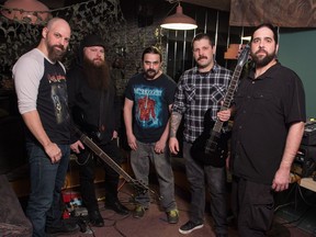 Members of the metal band Planet Eater pose for a photo in their jam space in Regina.