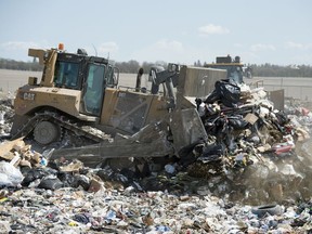 Heavy equipment moves trash around at the City of Regina Landfill in Regina.