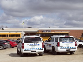 Members of the RCMP White Butte detachment sit outside Greenall High School in Balgonie on May 2, 2018.