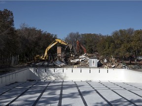 A pair of track-hoes from Silverado Demolition work on tearing down the former Wascana Pool in Wascana Centre in Regina.