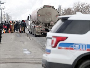 Following a breakdown in bargaining, Unifor picket line barricades were rebuilt outside the Co-op Refinery Complex at Gate 7 on Fleet Street in Regina, Saskatchewan on Feb. 1, 2020. Pickets are shown here collecting lunch from coolers stored inside the barricade.