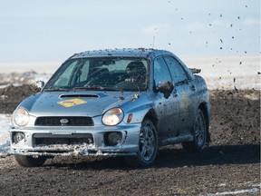 Driver Bob Schutzman slings a little mud with the rental car during Regina's Winter Rally X racing series on a rural property just south of Regina, Saskatchewan on Feb. 8, 2020. The car's transponder communicates with a device attached to the timing truck in line with the orange cones.