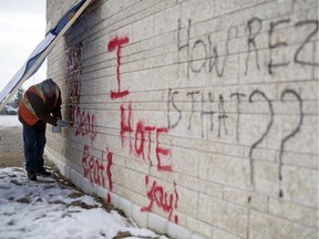 Darrel Treppel of Gorilla Property Services removes graffiti from the exterior of the First Nations University  building in Regina on Friday, Feb. 14, 2020.