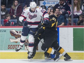 Regina Pats defenceman Kyle Walker collides with Brandon Wheat Kings forward Reid Perepeluk during second-period WHL action in Regina on Monday.