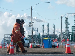 Unifor pickets walk the line at Gate 7 in front of the Co-op Refinery Complex on Fleet Street in Regina, Saskatchewan on Feb. 18, 2020.