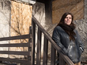 White Pony Lodge Patrol Coordinator Leah O'Malley stands in front of a boarded up home in the North Central neighbourhood of Regina, Saskatchewan on Feb 21, 2020. White Pony Lodge volunteers check around such buildings for used needles and other drug paraphernalia.