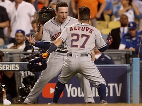 Jose Altuve of the Houston Astros celebrates with teammate Alex Bregman after hitting a home run against the Los Angeles Dodgers in Game 2 of the World Series at Dodger Stadium on October 25, 2017 in Los Angeles. (Christian Petersen/Getty Images)