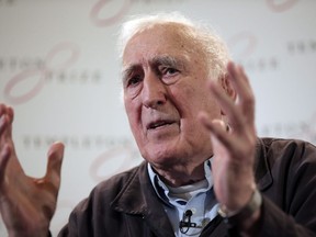 Jean Vanier, the founder of L'ARCHE, gestures as he talks during a news conference, in central London, Wednesday, March 11, 2015. Canadian schools and organizations associated with the late Jean Vanier are facing difficult decisions in the wake of a report that found the once-revered figure sexually abused at least six women.THE CANADIAN PRESS/AP, Lefteris Pitarakis