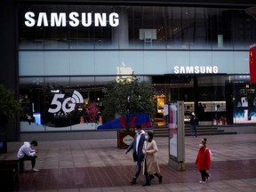 People wears masks in front a Samsung Store at a main shopping area as the country is hit by an outbreak of the new coronavirus in downtown Shanghai, China February 21, 2020.