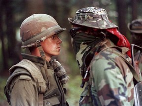 Canadian soldier Patrick Cloutier and Brad Laroque (alias "Freddy Kruger") come face to face in a tense standoff at the Kahnesatake reserve in Oka, Que. on Sept. 1, 1990.