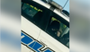 A screenshot from a video appearing to show a Regina police officer eating while behind the wheel.