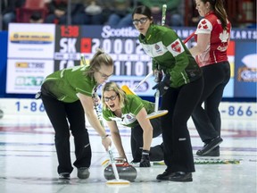 Saskatchewan third Stefanie Lawton, centre, calls on her front end of second Jessie Hunkin, left, and lead Kara Thevenot during the Scotties Tournament of Hearts.