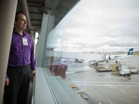 James Bogusz, president and CEO of the Regina Airport Authority, stands looking out at the tarmac at the Regina International Airport on Aug. 27, 2019.