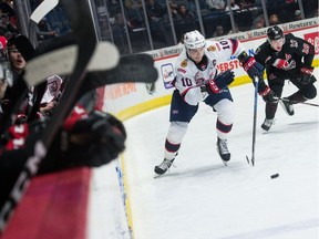 The Regina Pats' Austin Pratt, 10, carries the puck while being pursued by the Moose Jaw Warriors' Tate Popple at the Brandt Centre on Dec. 28. The Pats and Warriors are to meet again Tuesday night in Regina.