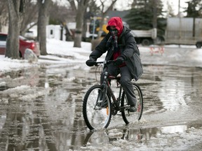 A cyclist makes their way through a puddle in the city's south end in Regina on Tuesday, March 3, 2020.