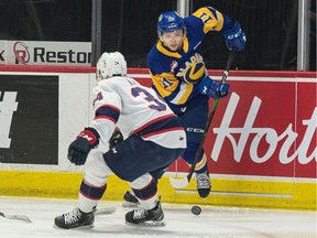 The Saskatoon Blades' Tristen Robins (11) works his way past the Regina Pats' Riley Krane (34) during WHL action at the Brandt Centre on Saturday.