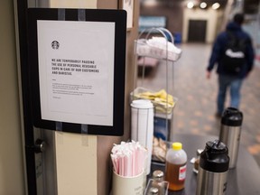 A sign at The Grind coffee booth indicates no reusable cups are to be used due to risks posed by the COVID-19 virus at the University of Regina in Regina, Saskatchewan on Mar. 10, 2020.