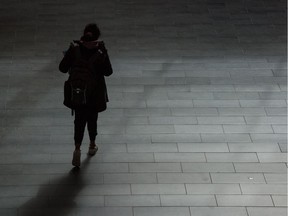 A woman walks through a nearly-deserted RIC building in the University of Regina in Regina, Saskatchewan on Mar 14, 2020.