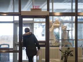 A woman leaves a nearly deserted AdHum building in the University of Regina in Regina, Saskatchewan on Mar 14, 2020. Post-secondary institutions are switching to online courses as public gathering spaces across the province and country shut down.