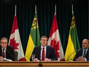 Saskatchewan Premier Scott Moe speaks to reporters at a media conference regarding the province's response to COVID-19 at the Saskatchewan Legislative Building in Regina on March 18, 2020. On the right is Dr. Saqib Shahab.