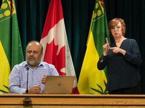 Saskatchewan's chief medical health officer Dr. Saqib Shahab, left, and ASL interpreter Karen Nurkowski from Saskatchewan Deaf and Hard of Hearing answer questions from the media during a news conference regarding the province's response to COVID-19 held at the Saskatchewan Legislative Building in Regina, Saskatchewan on Mar. 19, 2020.