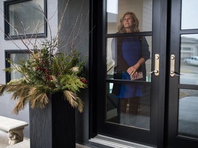 Regina's Ward 4 Councillor Lori Bresciani stands in the window of her home in Regina, Saskatchewan on March 24, 2020. Bresciani is working from home during the COVID-19 pandemic.