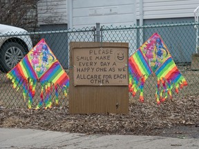 A sign on McAra Street urges people to smile during the COVID-19 pandemic.