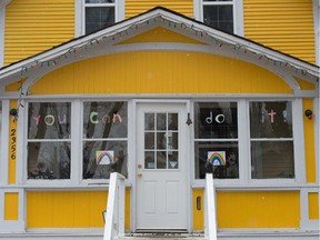 A cheery yellow home displays a message of encouragement for passers by during the COVID-19 pandemic in Regina, Saskatchewan on March 25, 2020. BRANDON HARDER/ Regina Leader-Post