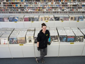 Janelle Baumet, part owner of Vintage Vinyl, stands in the shop on 11th Avenue in Regina, Saskatchewan on March 27, 2020. While the inside of the shop is closed to customers due to COVID 19, Baumet and her team are doing a curbside service.