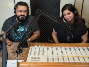 Radio DJs Aziz Sabuwala, left, and Laila Hirani stop for a photo during a broadcast of their show Bollywood Mehfil at CJTR on Feb 29, 2020.