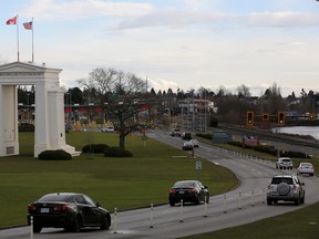 Cars bound for the United States from Canada pass the Peace Arch border monument in Surrey, British Columbia, Canada February 16, 2017.