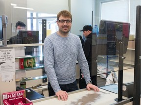 Lakeview Fine Foods owner Charles Tooke stands behind the till in his store on Hill Avenue in Regina on March 27, 2020.